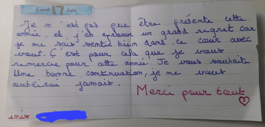 A young child curiously holding a small violin.